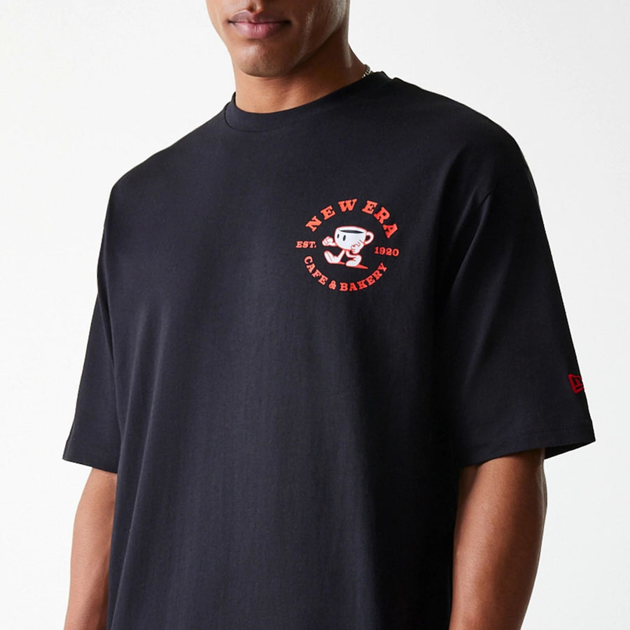 The Male model is wearing New Era Cafe Graphic Black Oversized T-Shirt 5