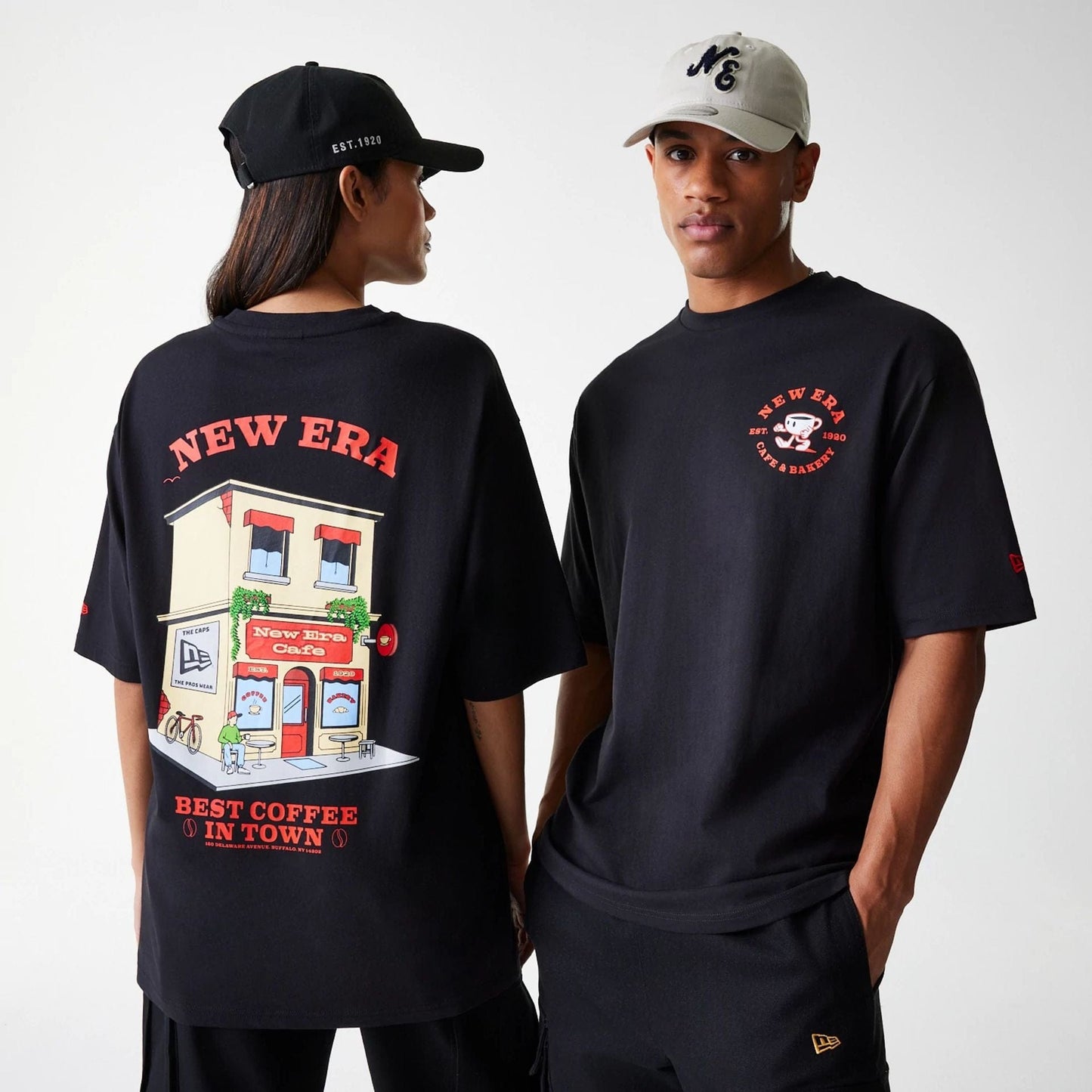 The Male model is wearing New Era Cafe Graphic Black Oversized T-Shirt 1