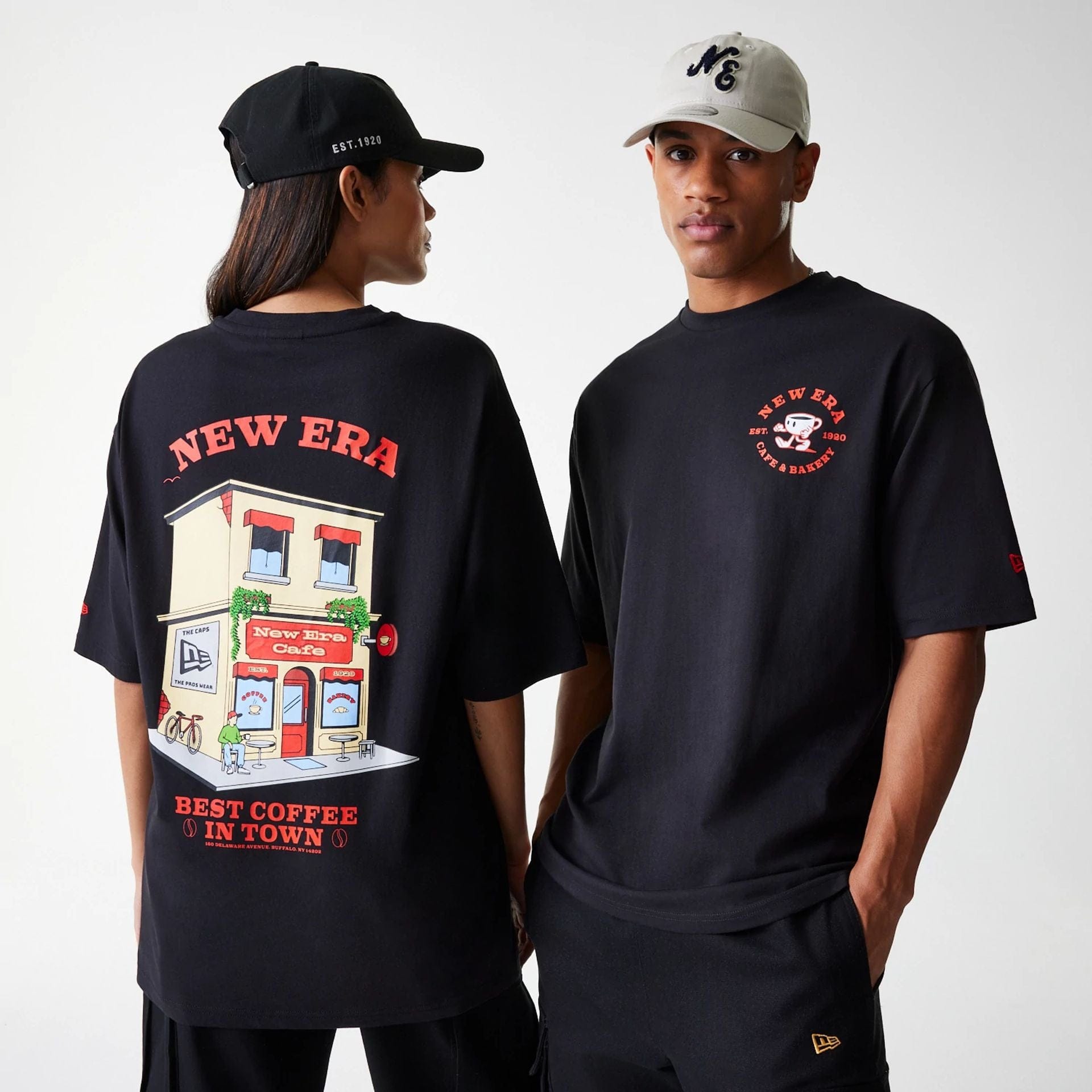The Male model is wearing New Era Cafe Graphic Black Oversized T-Shirt 1