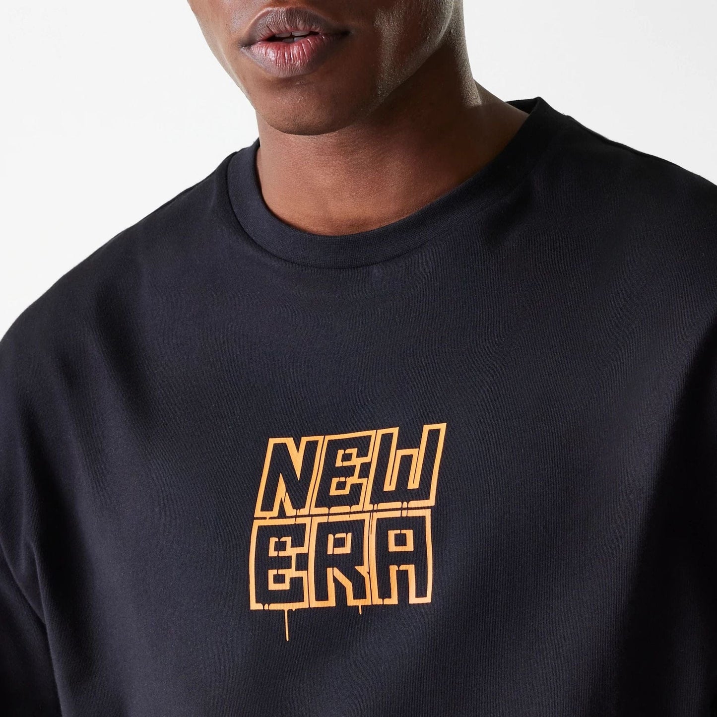 The Male model is wearing New Era Graffiti Graphic Black Oversized T-Shirt 7