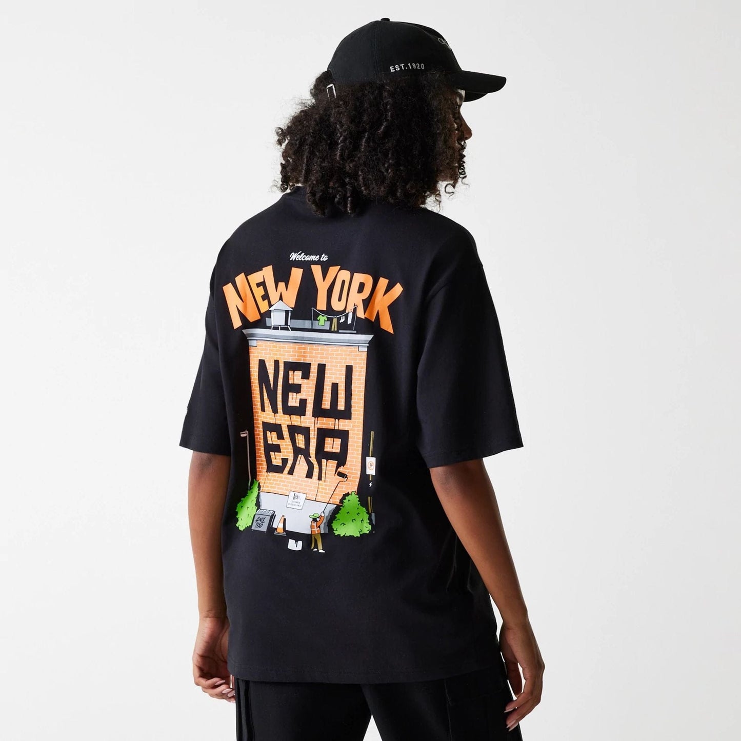 The Male model is wearing New Era Graffiti Graphic Black Oversized T-Shirt 4
