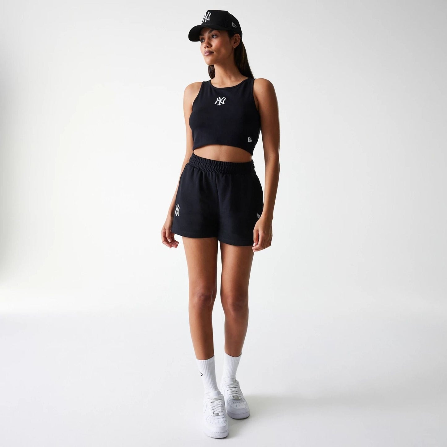 The Female model is wearing New York Yankees Womens MLB Midi League Essential Black Crop Tank Top 8