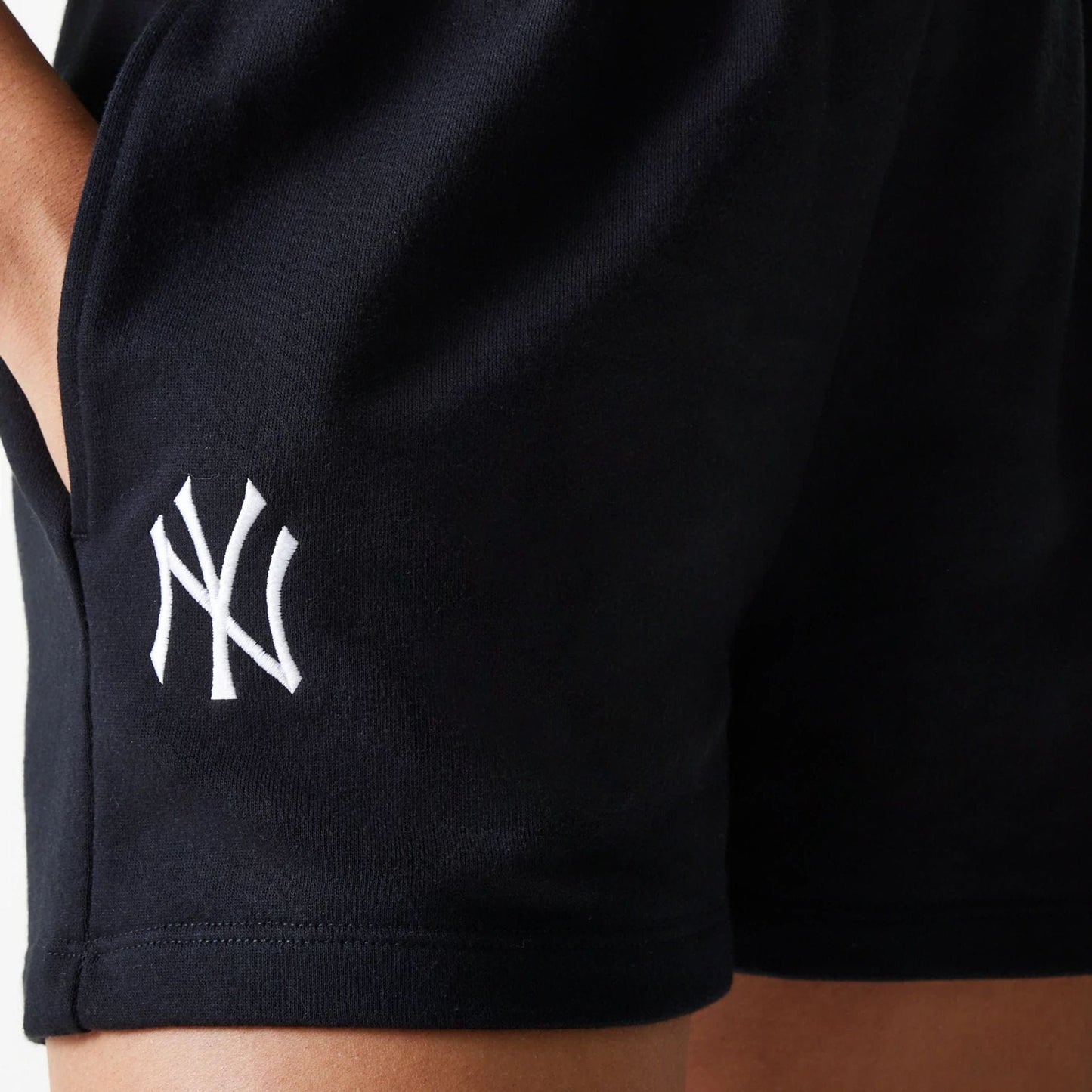 The Female model is wearing New York Yankees Womens MLB Midi League Essential Black Shorts 3