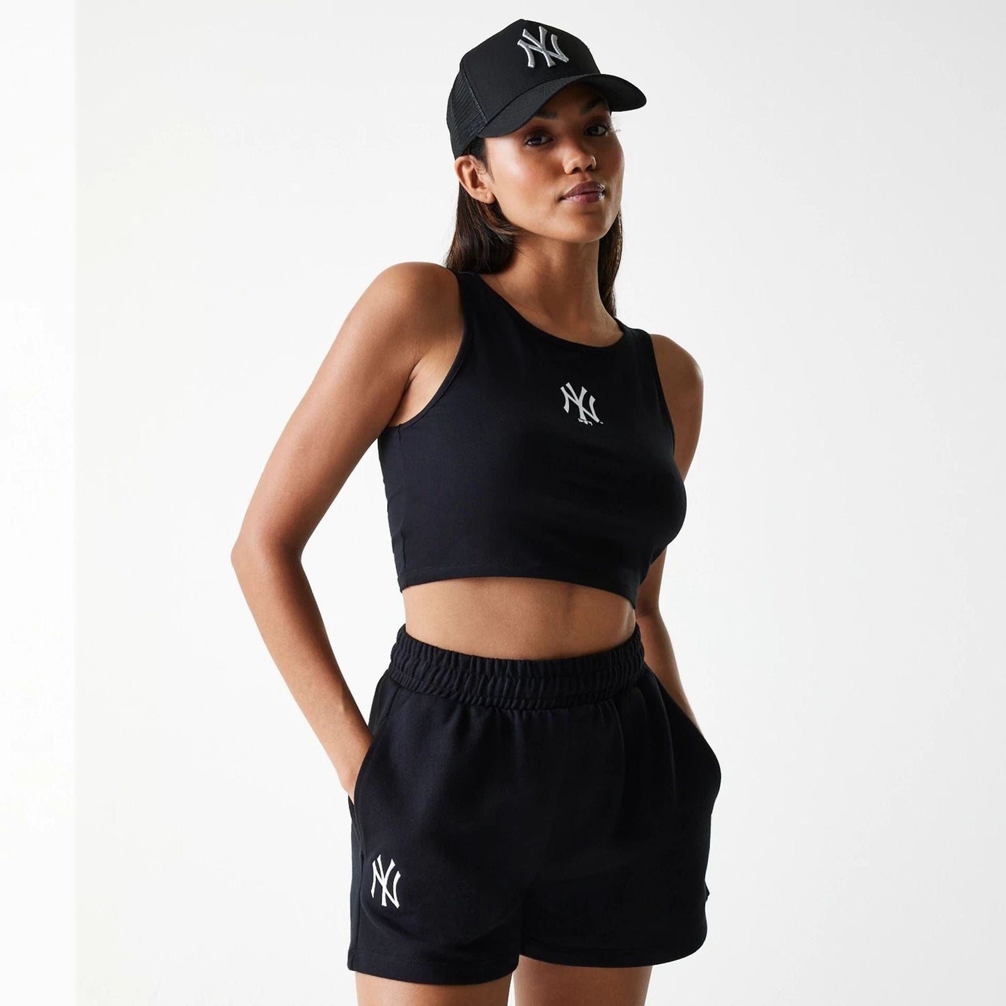 The Female model is wearing New York Yankees Womens MLB Midi League Essential Black Shorts 1