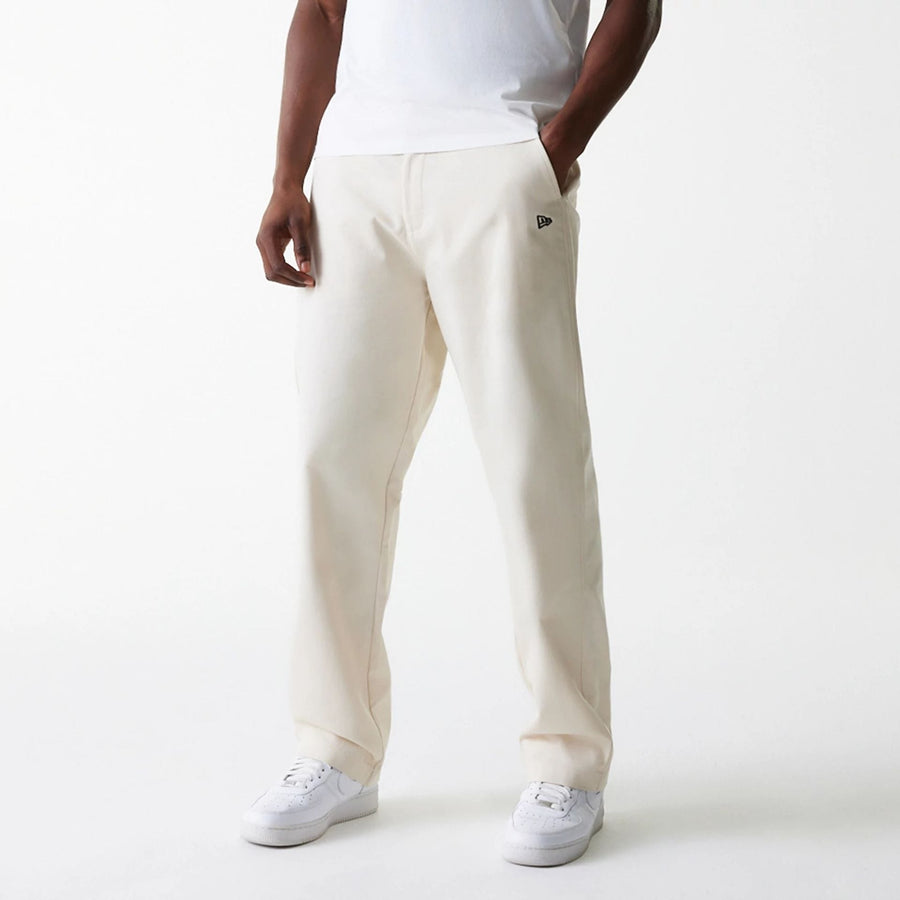 The Male model is wearing New Era Light Beige Chino Trousers 3