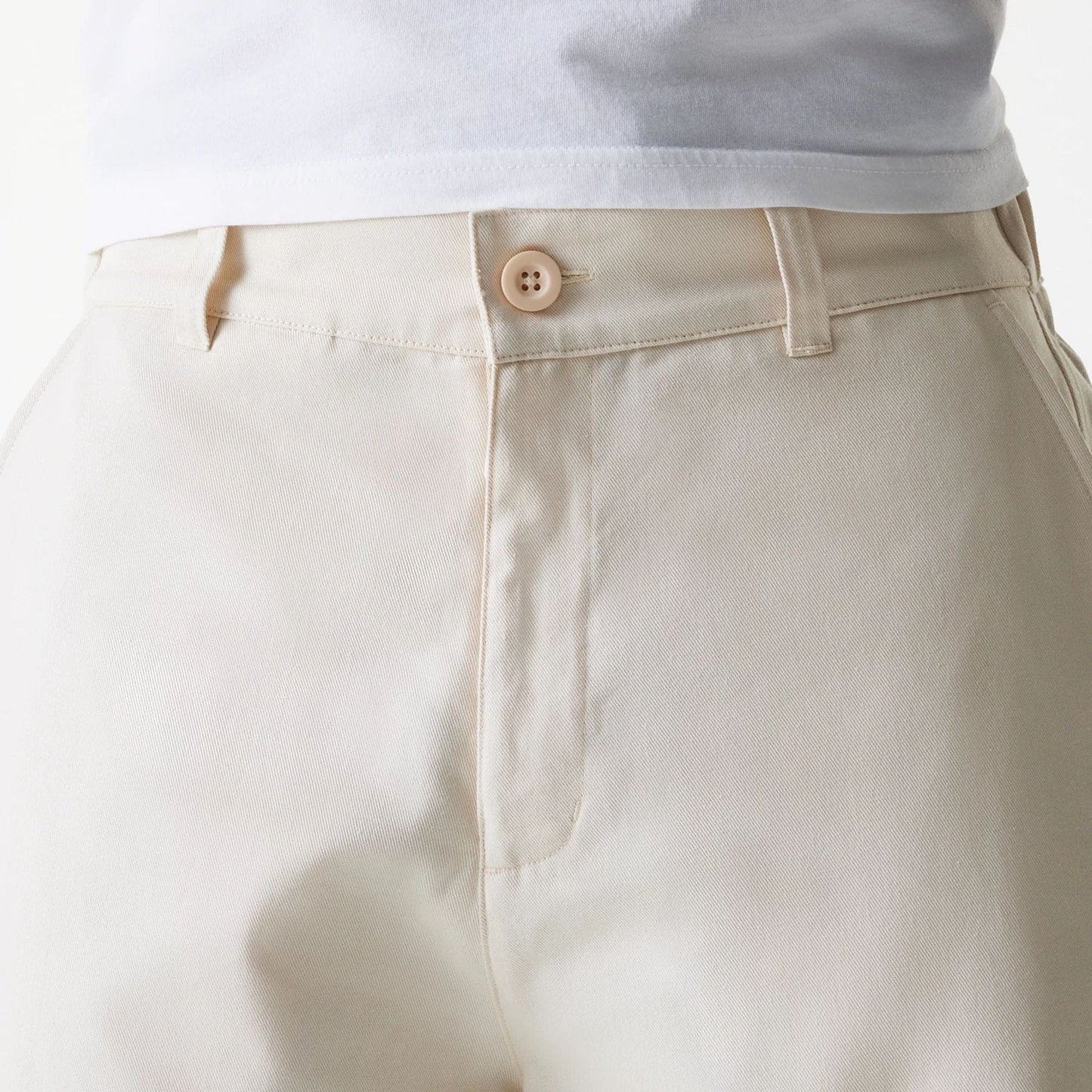 The Male model is wearing New Era Light Beige Chino Trousers 6