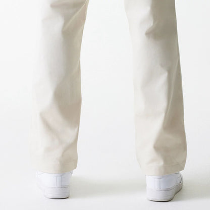 The Male model is wearing New Era Light Beige Chino Trousers 7