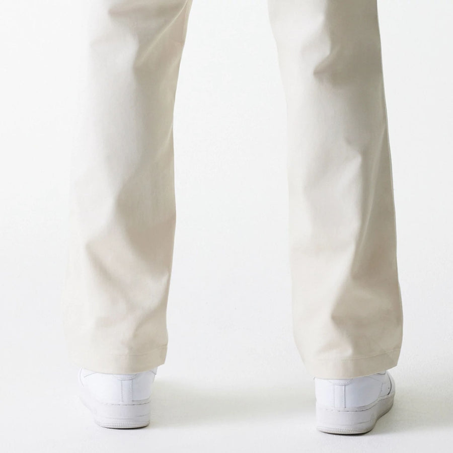 The Male model is wearing New Era Light Beige Chino Trousers 7