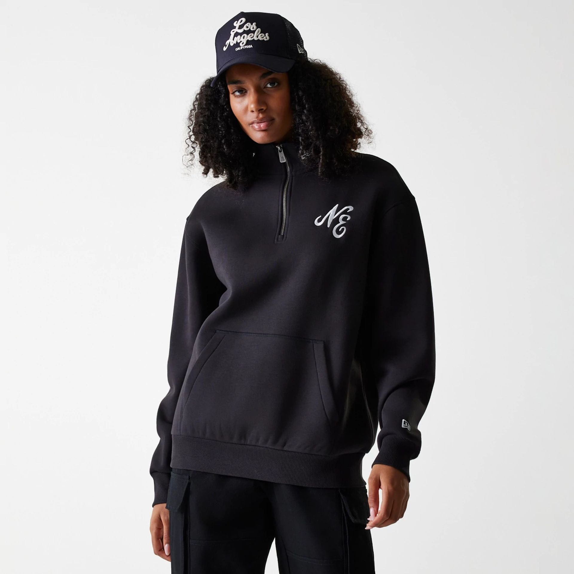 The Male model is wearing New Era Lifestyle Black 1/4 Zip Sweater 4