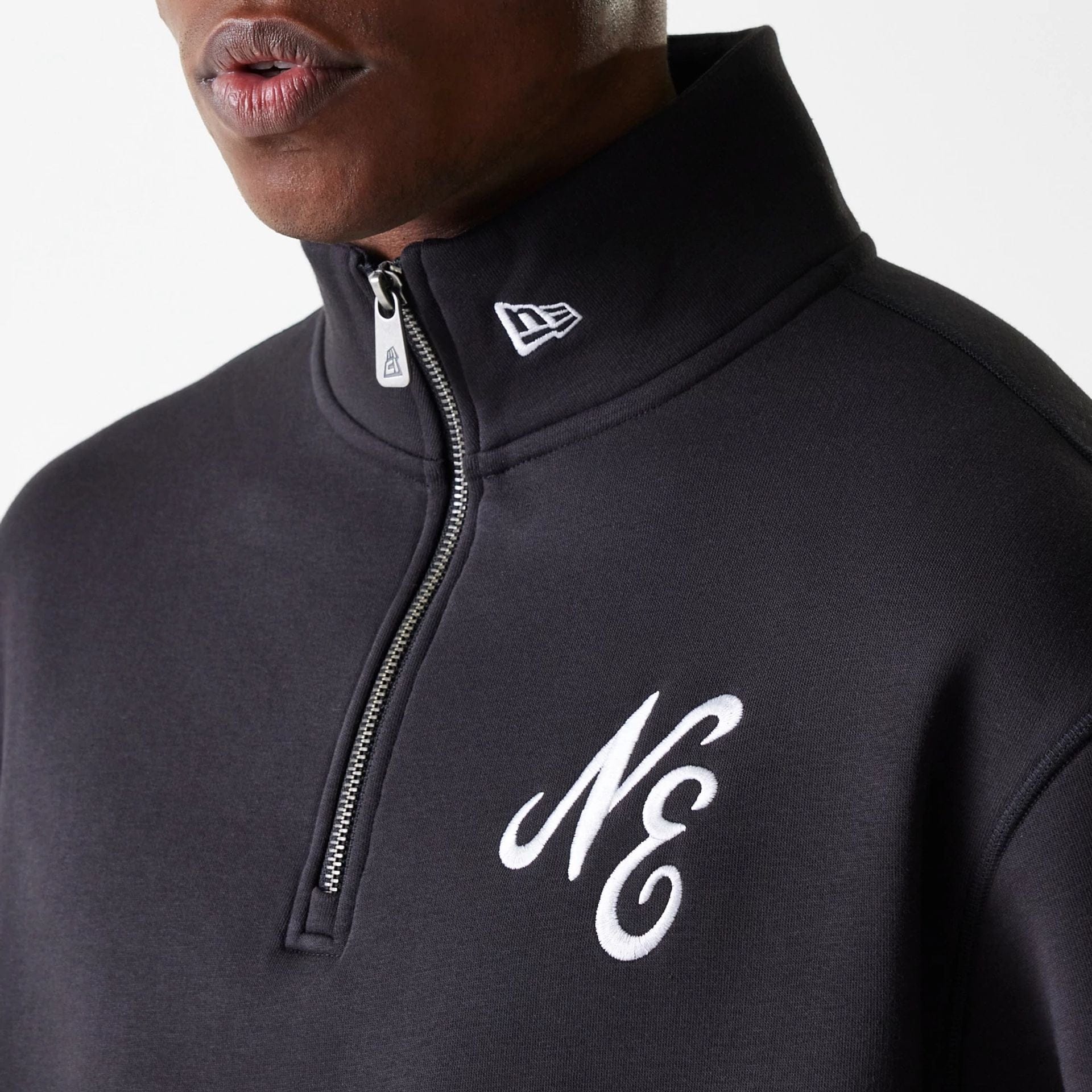 The Male model is wearing New Era Lifestyle Black 1/4 Zip Sweater 6