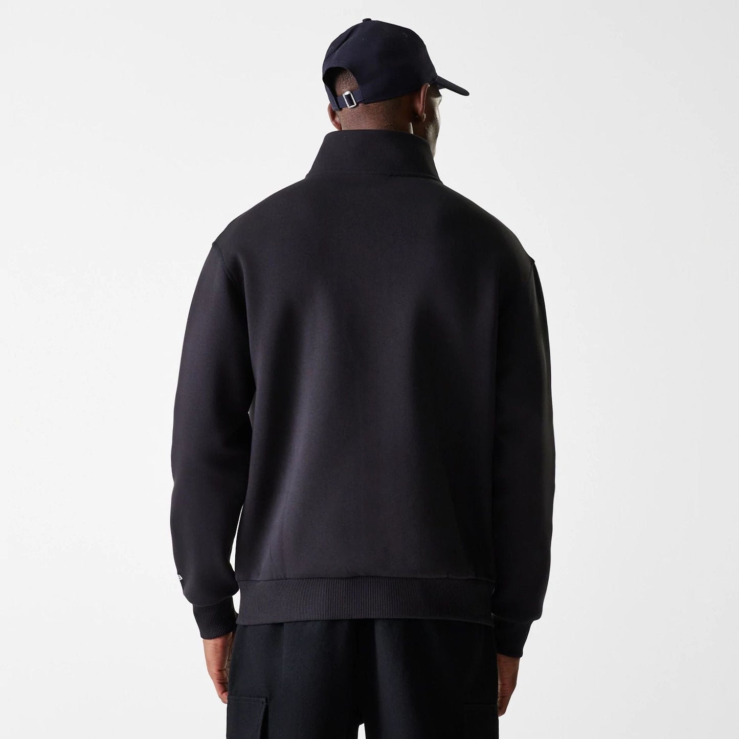 The Male model is wearing New Era Lifestyle Black 1/4 Zip Sweater 2