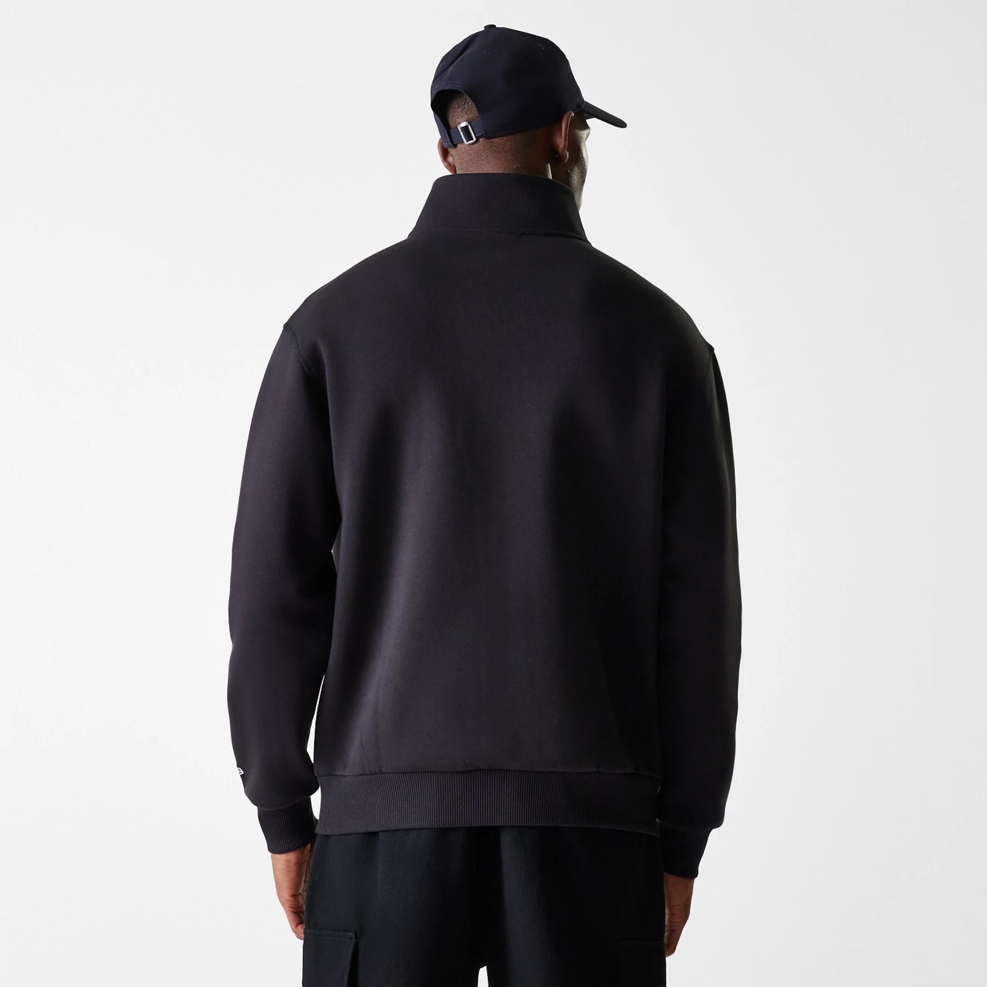 The Male model is wearing New Era Lifestyle Black 1/4 Zip Sweater 2