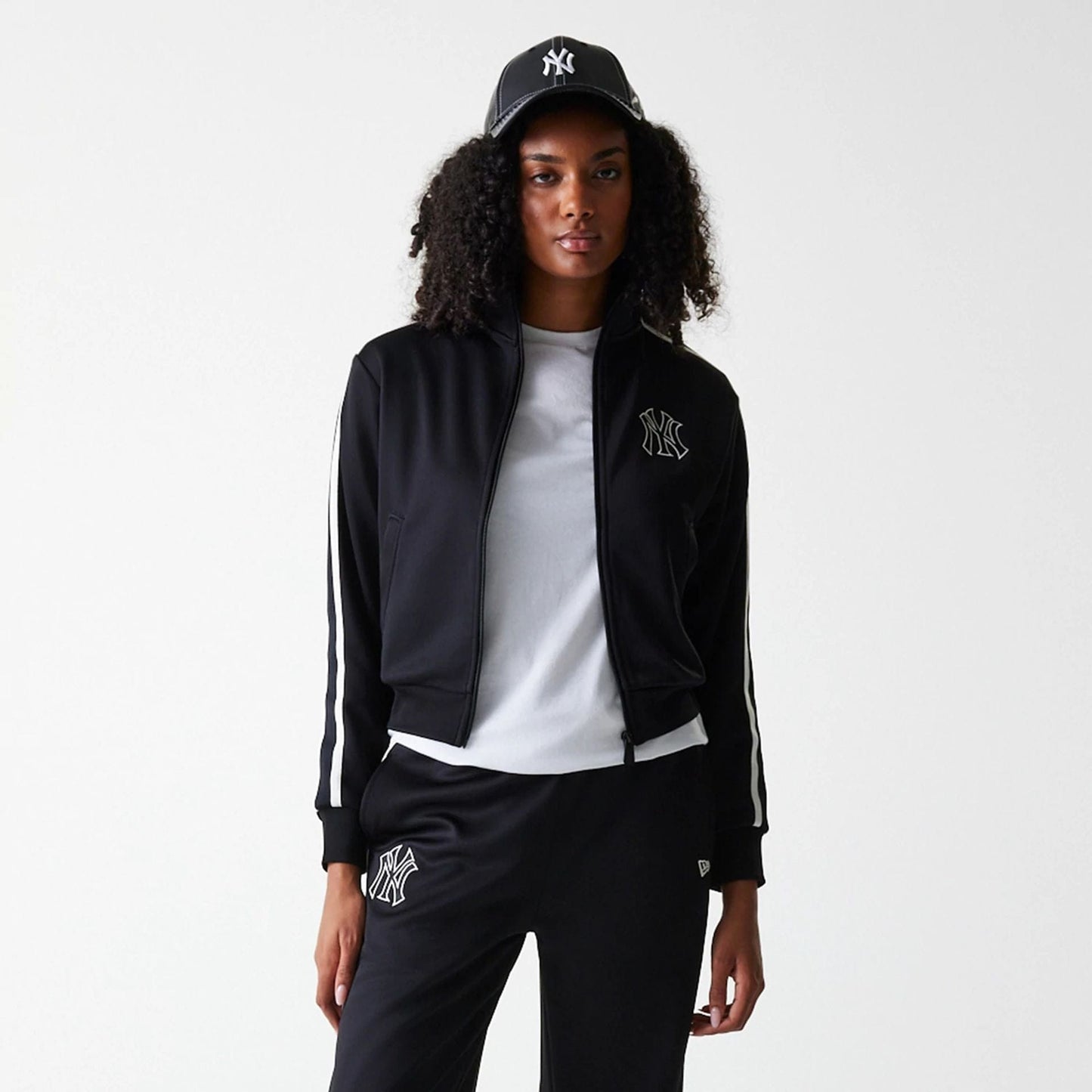 The Female model is wearing New York Yankees Womens MLB Midi Logo Black Track Jacket 3
