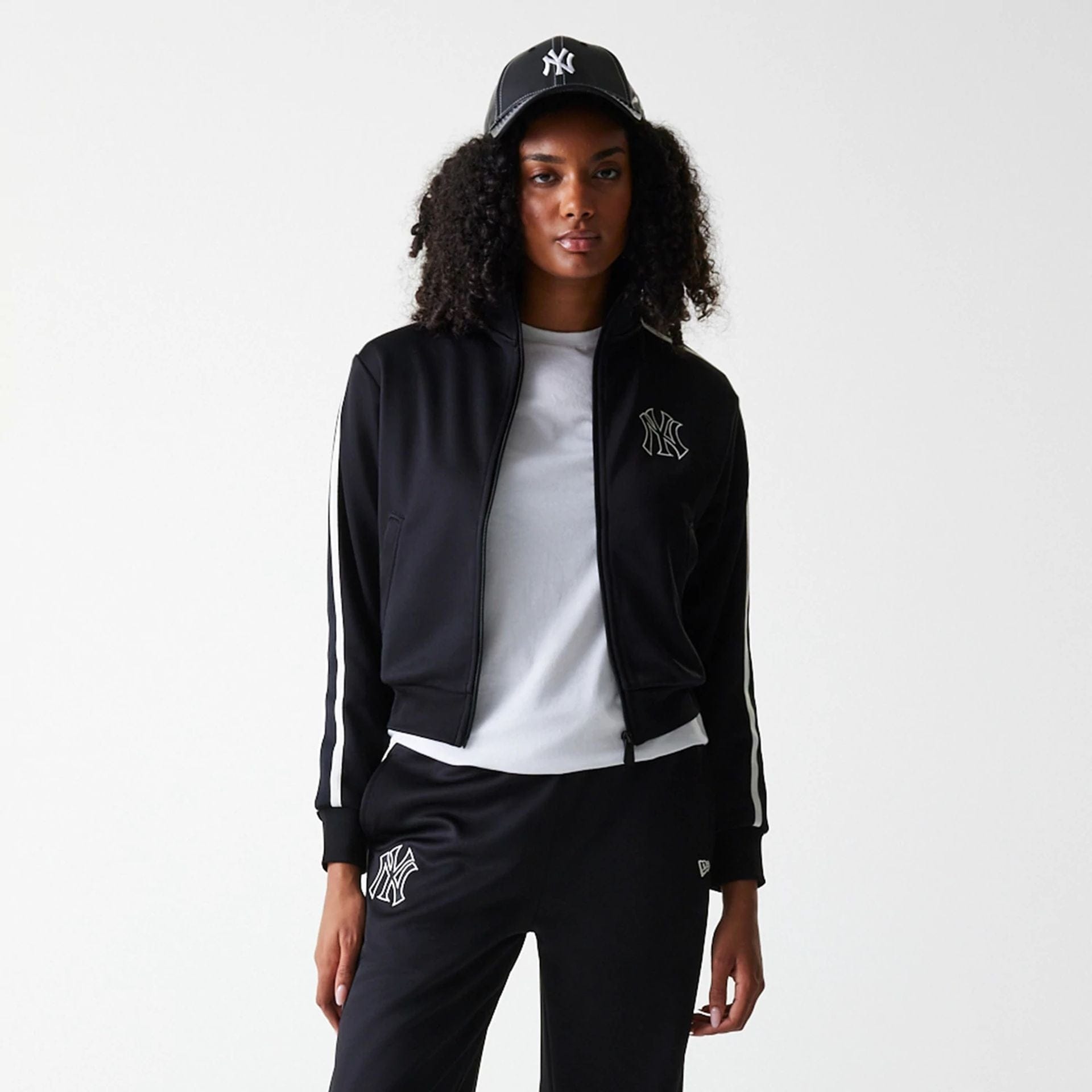 The Female model is wearing New York Yankees Womens MLB Midi Logo Black Track Jacket 3