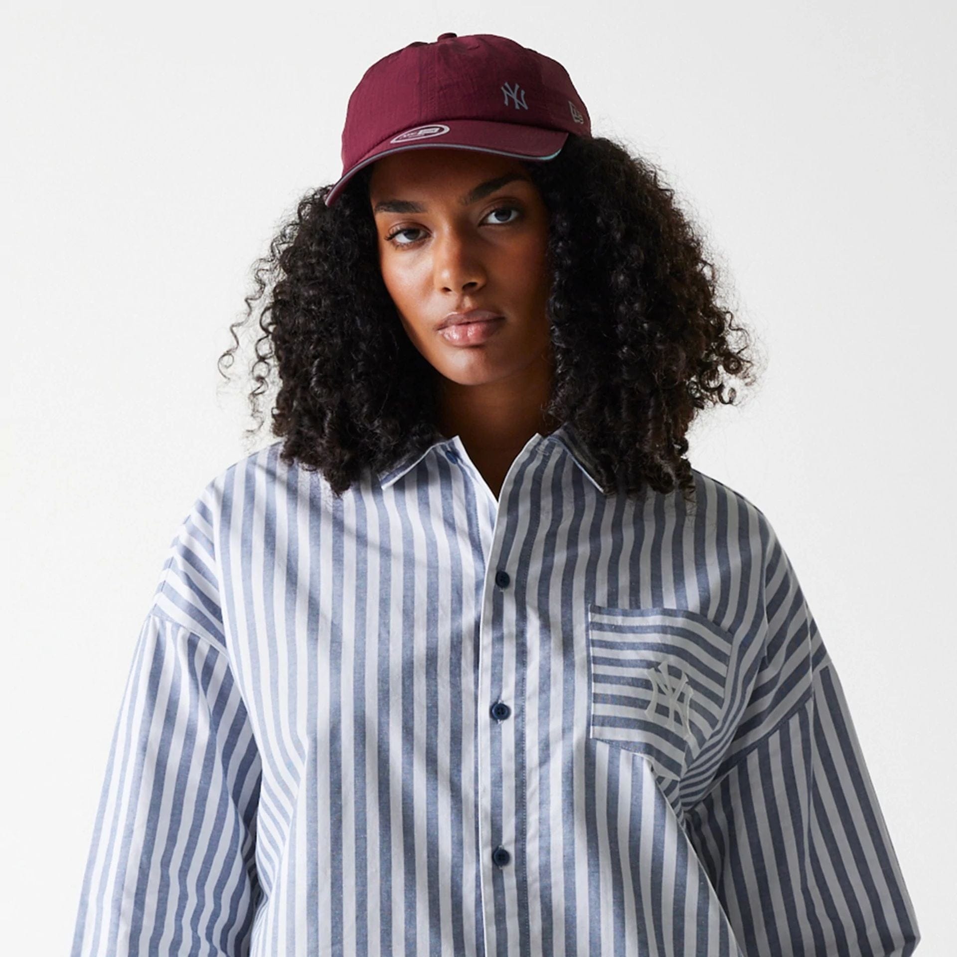 The Female model is wearing New York Yankees Womens MLB Stripe Dark Blue Long Sleeve Shirt 6