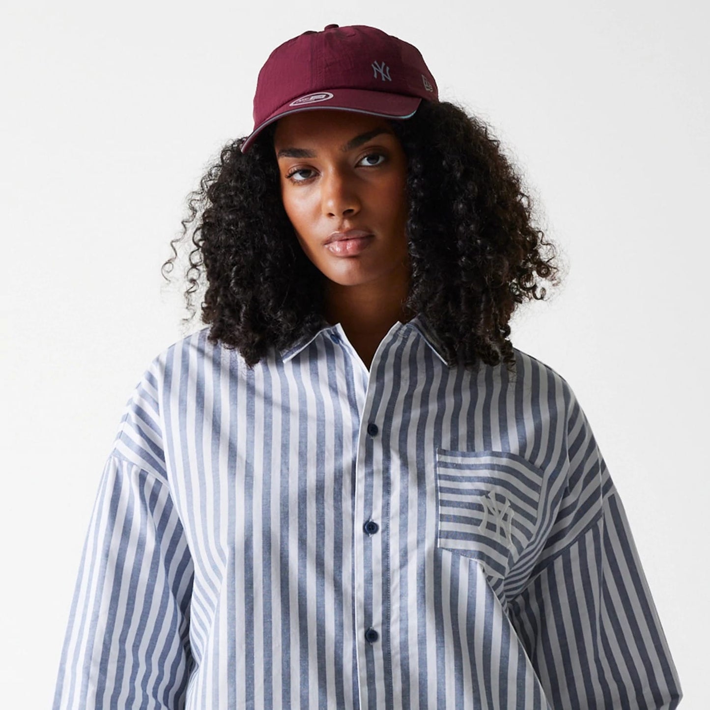 The Female model is wearing New York Yankees Womens MLB Stripe Dark Blue Long Sleeve Shirt 6