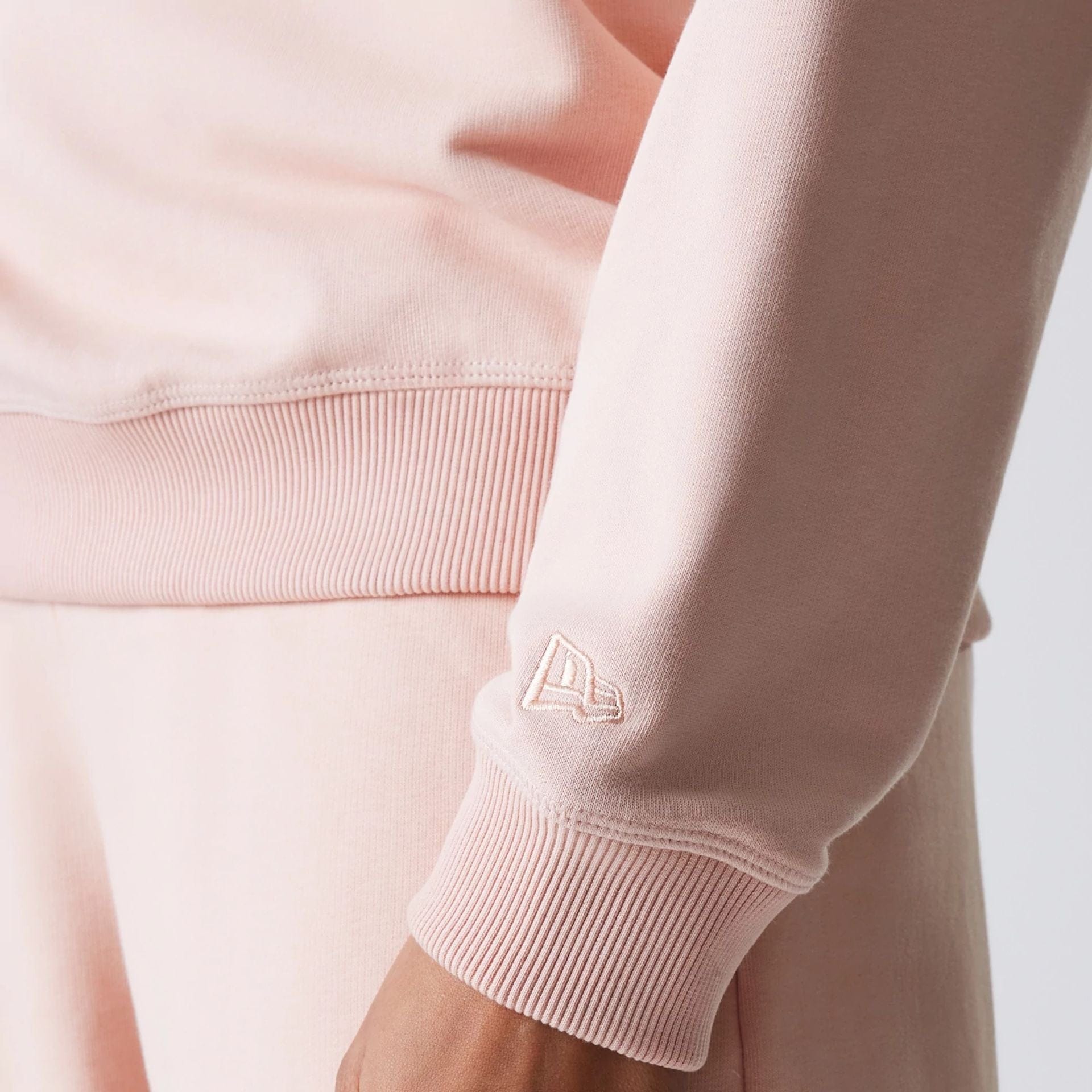 The Female model is wearing New York Yankees Womens MLB Tonal Graphic Pastel Pink Oversized Crew Neck Sweater 5