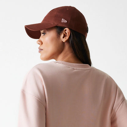 The Female model is wearing New York Yankees Womens MLB Tonal Graphic Pastel Pink Oversized Crew Neck Sweater 7