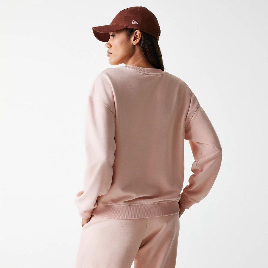The Female model is wearing New York Yankees Womens MLB Tonal Graphic Pastel Pink Oversized Crew Neck Sweater 2