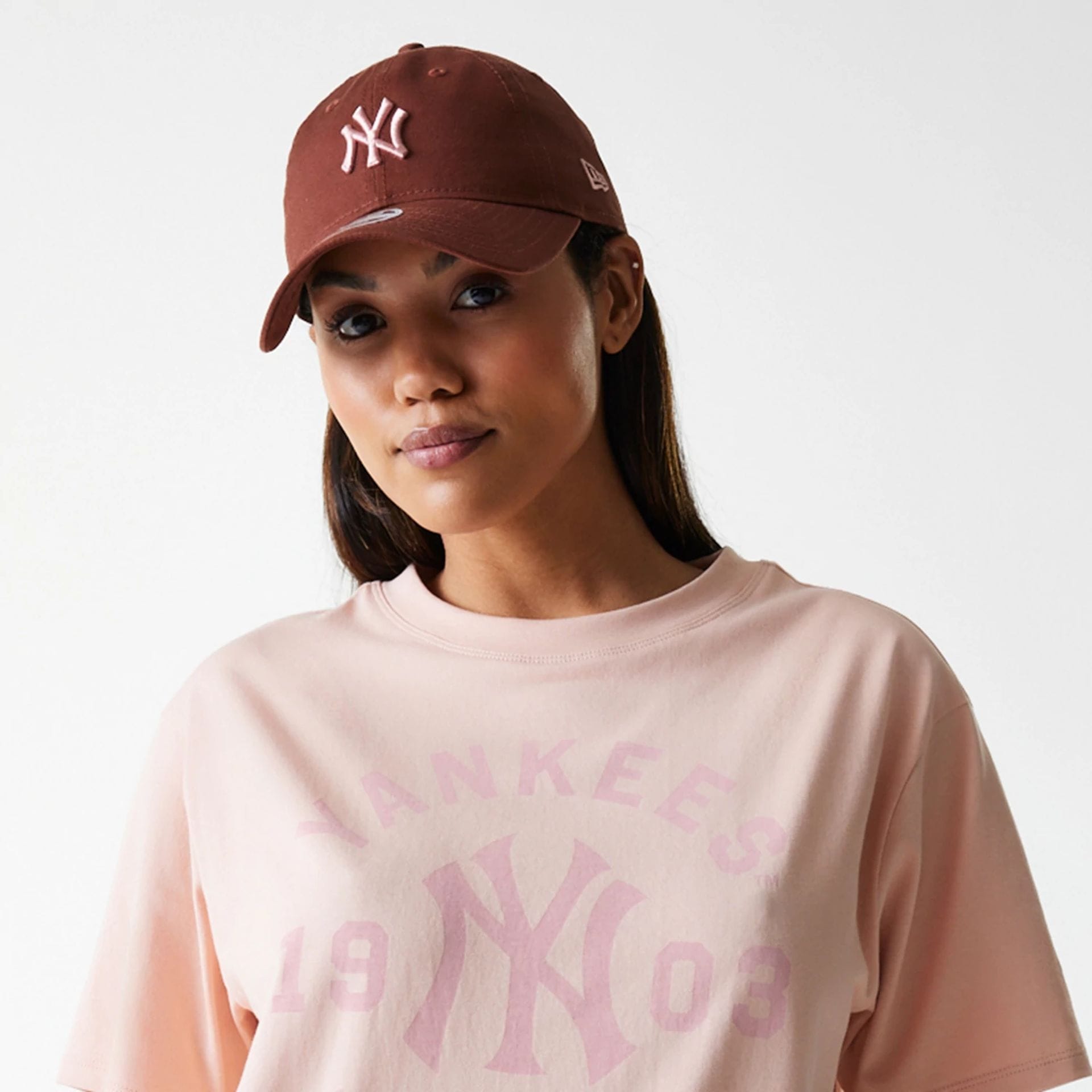 The Female model is wearing New York Yankees Womens MLB Tonal Graphic Pastel Pink Oversized T-Shirt 3