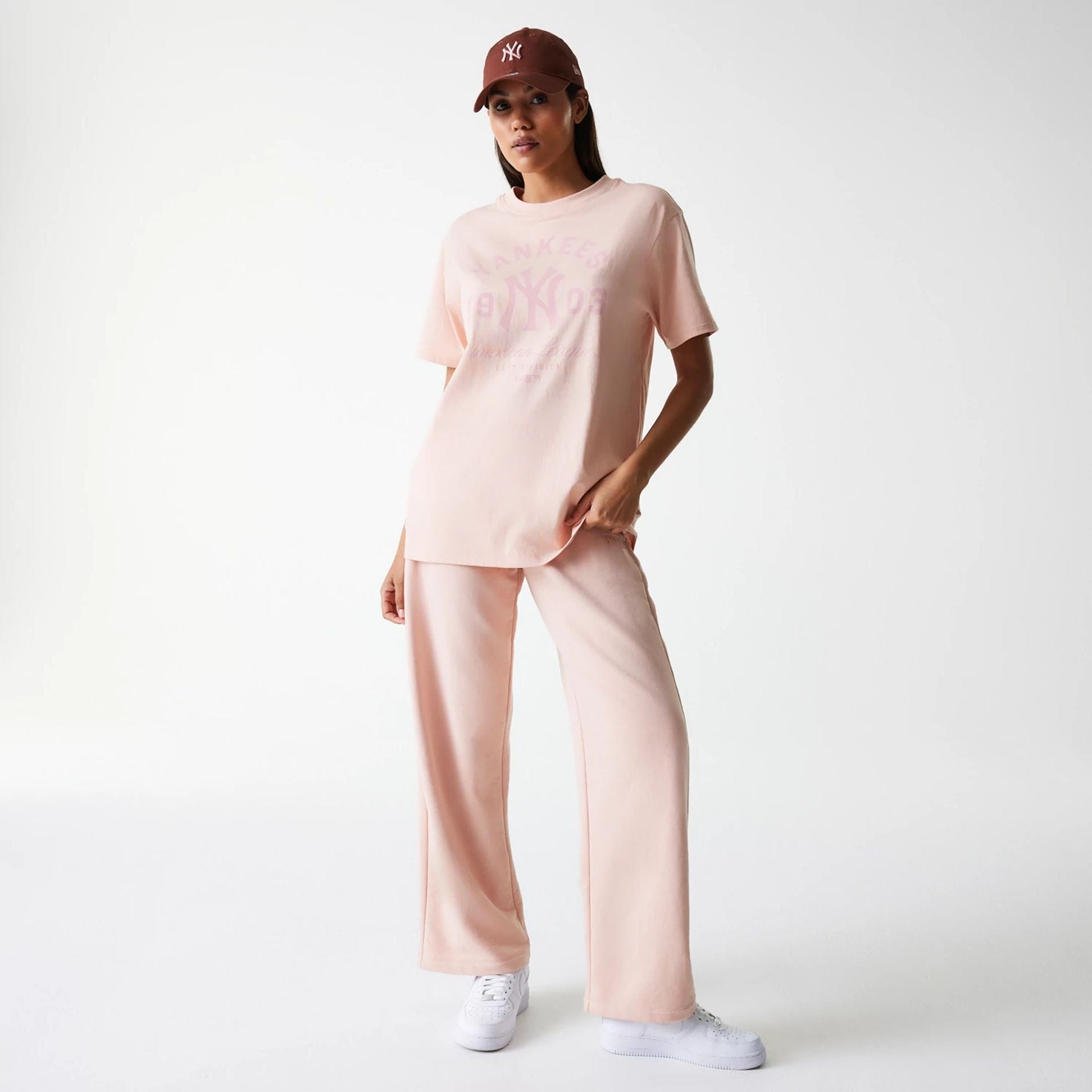 The Female model is wearing New York Yankees Womens MLB Tonal Graphic Pastel Pink Oversized T-Shirt 5
