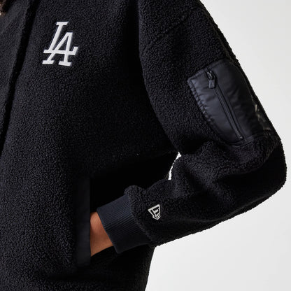 New Era LA Dodgers Womens MLB Black Oversized Sherpa Bomber Jacket, side view showing a black zip pocket on the left sleeve, a white embroidered LA logo on the chest, and a raised New Era logo on the black cuff.