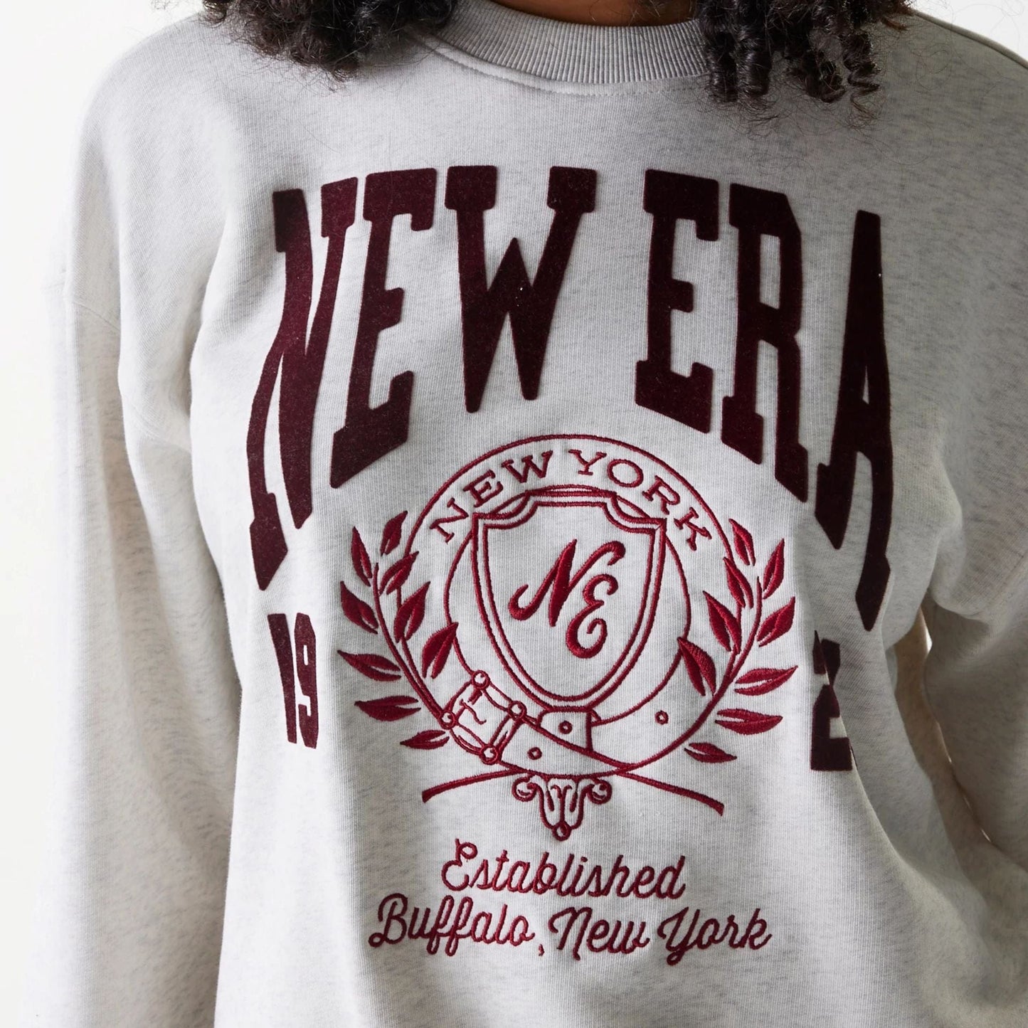 The Female model is wearing Womens New Era Crest Graphic Pastel Grey Crew Neck Sweater 5