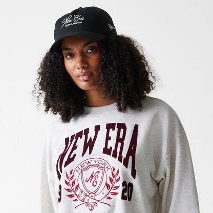 The Female model is wearing Womens New Era Crest Graphic Pastel Grey Crew Neck Sweater 3