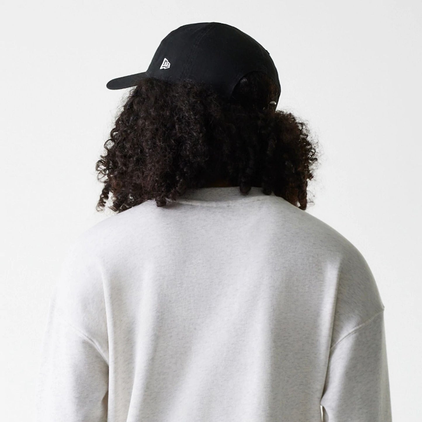 The Female model is wearing Womens New Era Crest Graphic Pastel Grey Crew Neck Sweater 7