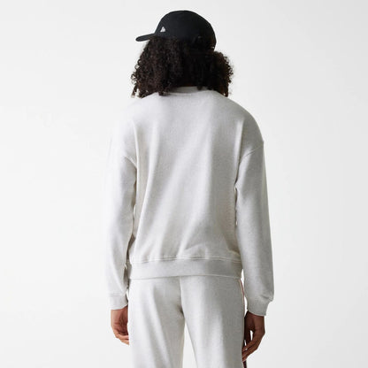 The Female model is wearing Womens New Era Crest Graphic Pastel Grey Crew Neck Sweater 2