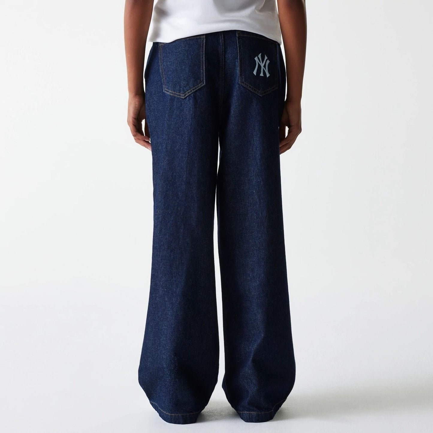 The Female model is wearing New York Yankees Womens MLB Dark Blue Wide Leg Denim Trousers 2