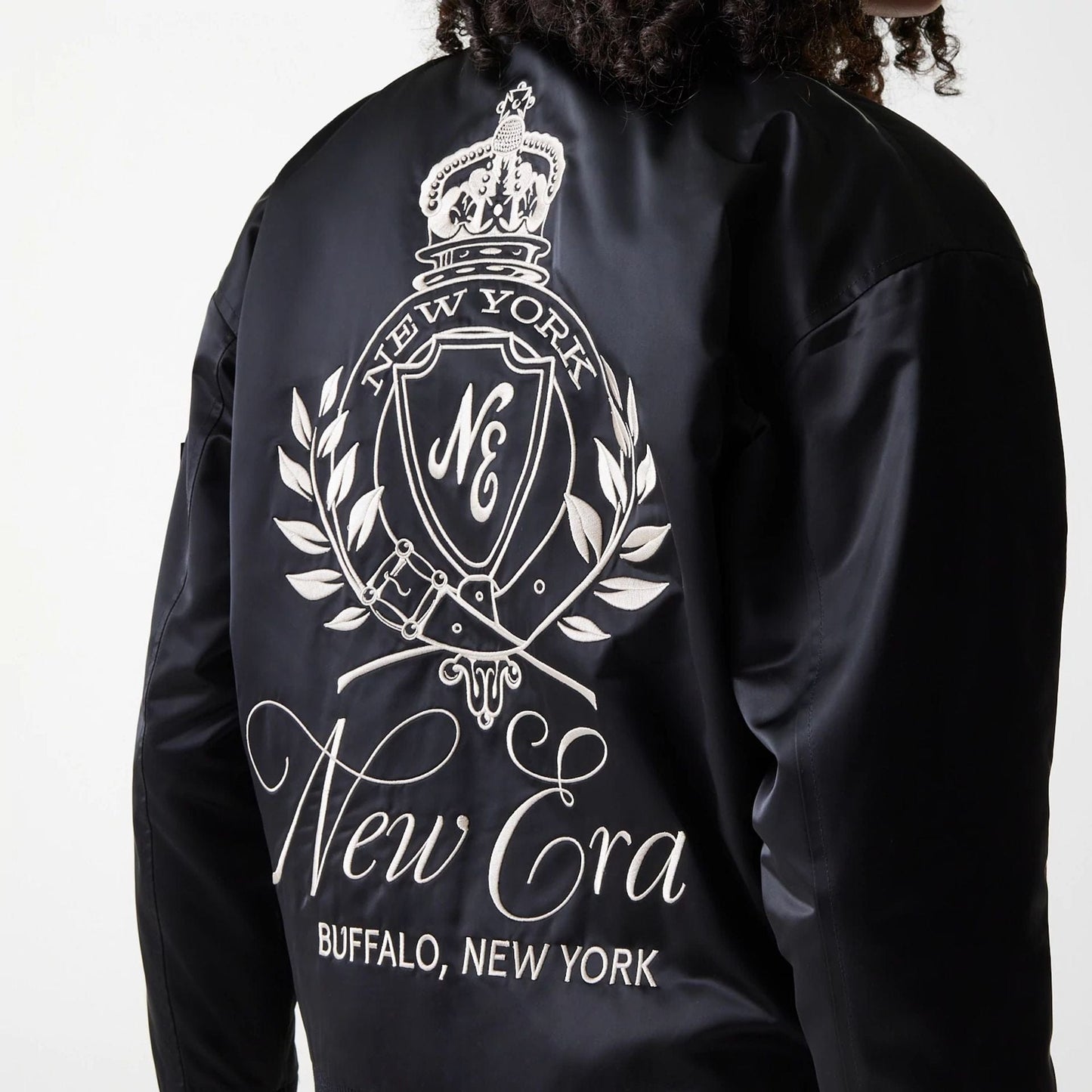 The Female model is wearing Womens New Era Satin Black Satin Bomber Jacket 4