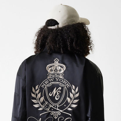 The Female model is wearing Womens New Era Satin Black Satin Bomber Jacket 5