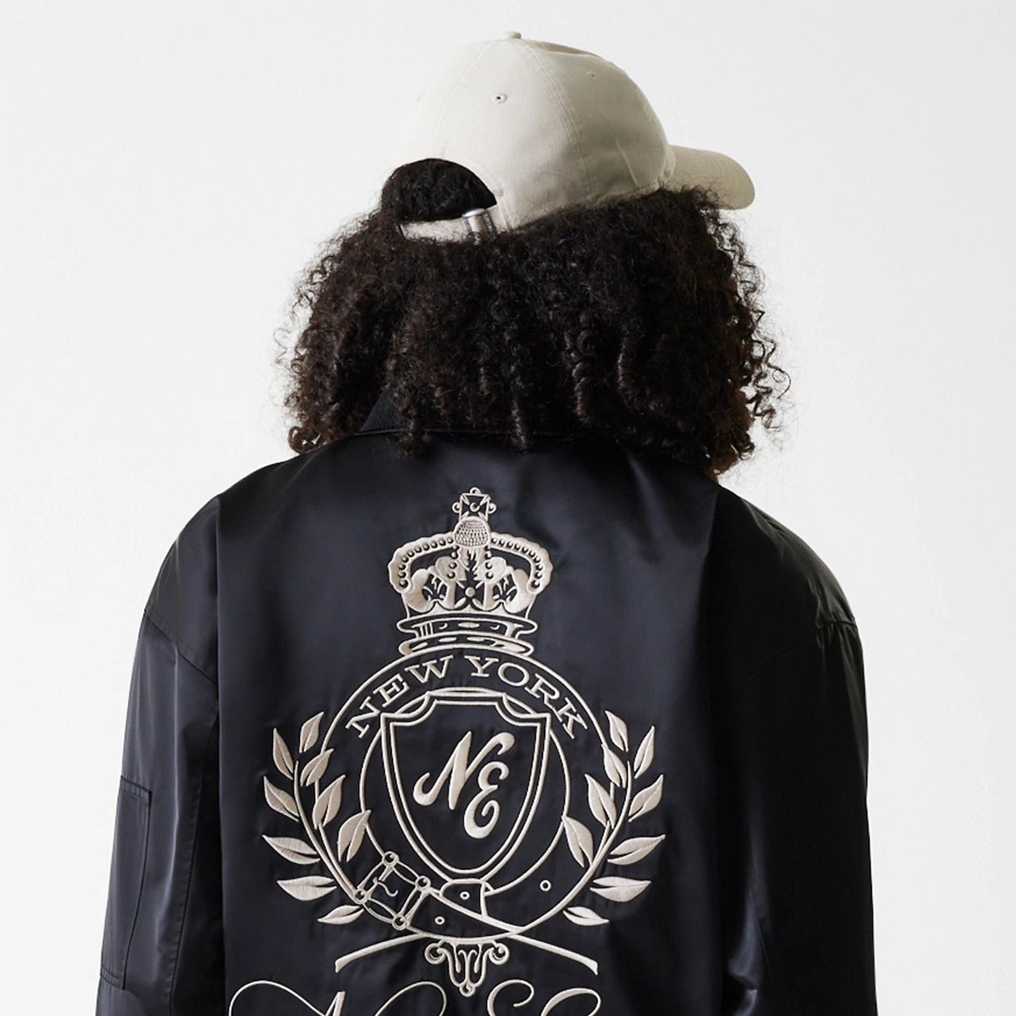 The Female model is wearing Womens New Era Satin Black Satin Bomber Jacket 5