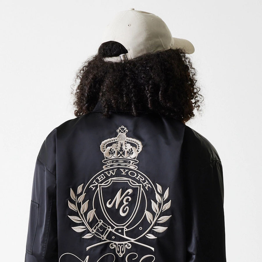 The Female model is wearing Womens New Era Satin Black Satin Bomber Jacket 5