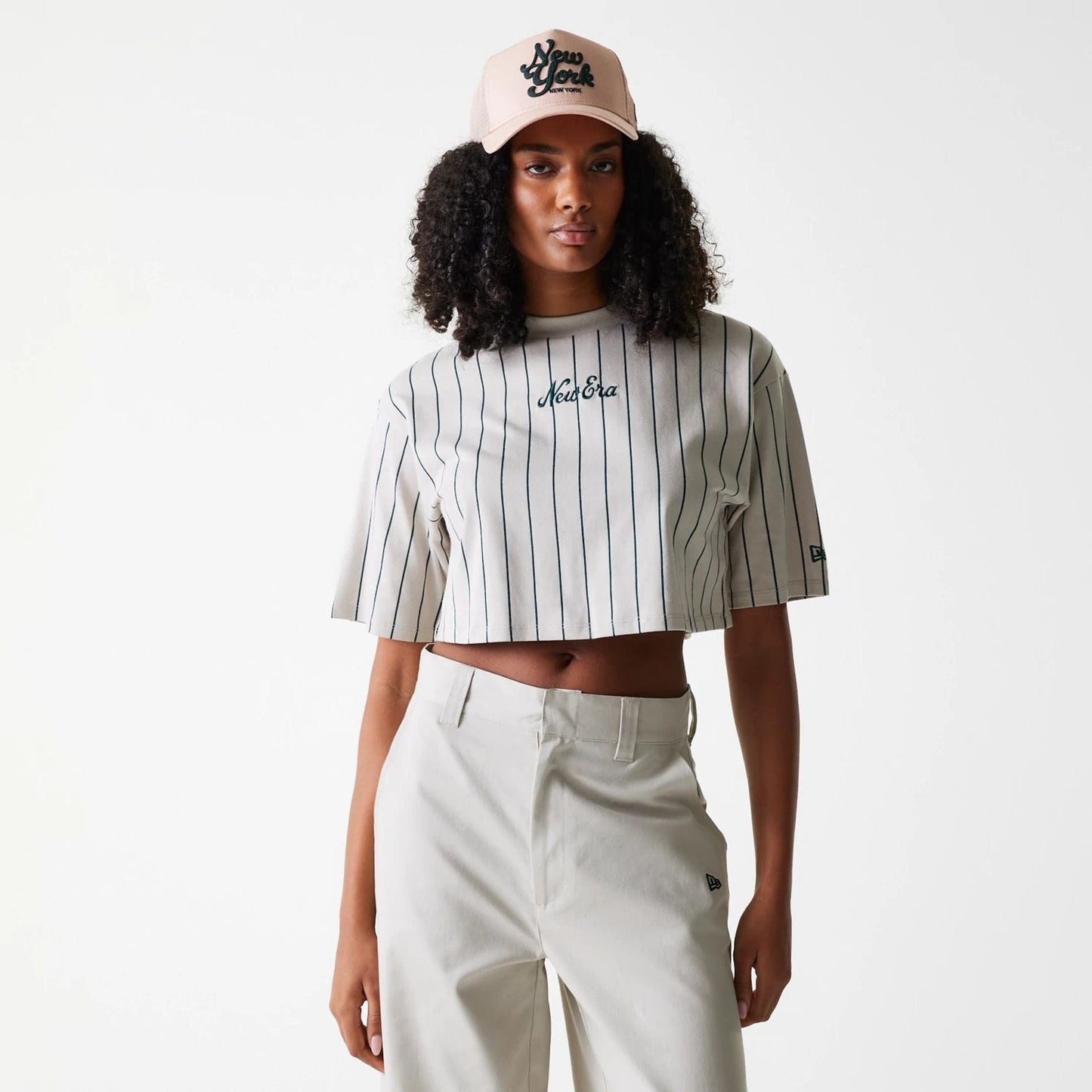 The Female model is wearing Womens New Era Pinstripe Light Beige Crop T-Shirt 1