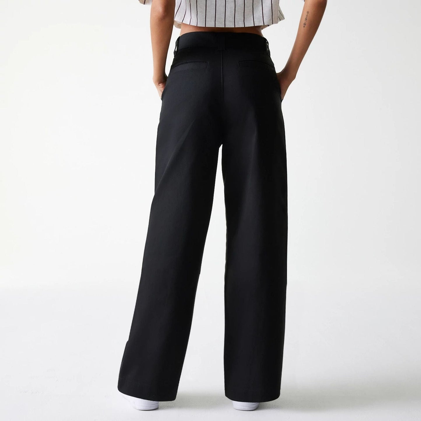 The Female model is wearing Womens New Era Black Wide Leg Chino Trousers 2