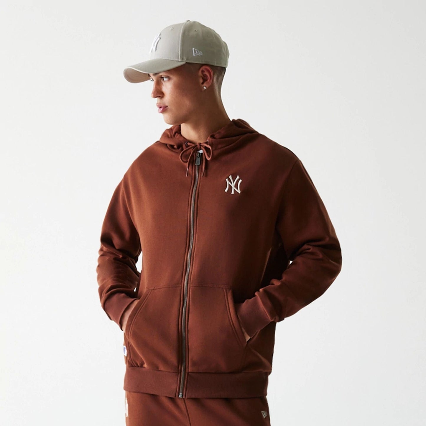 The Male model is wearing New York Yankees MLB Midi League Essential Brown Oversized Full Zip Hoodie 3