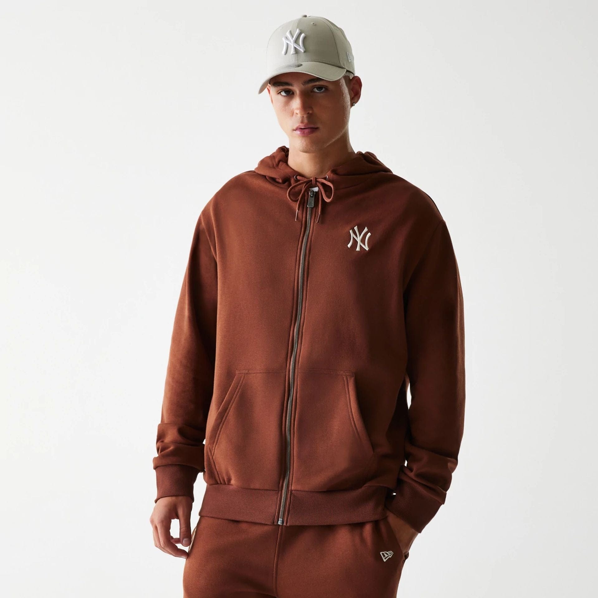 The Male model is wearing New York Yankees MLB Midi League Essential Brown Oversized Full Zip Hoodie 1