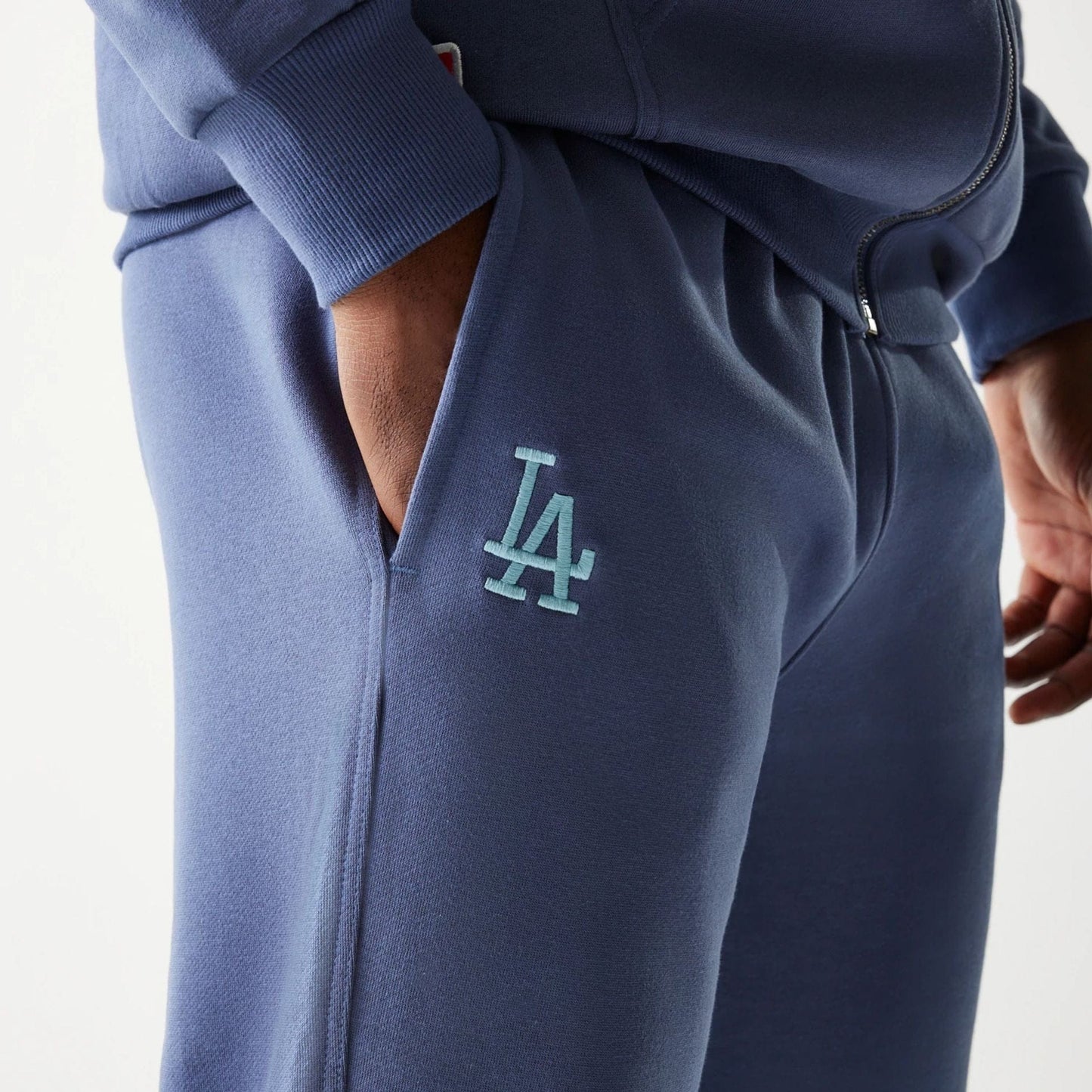 The Male model is wearing LA Dodgers MLB Midi League Essential Dark Blue Joggers 3