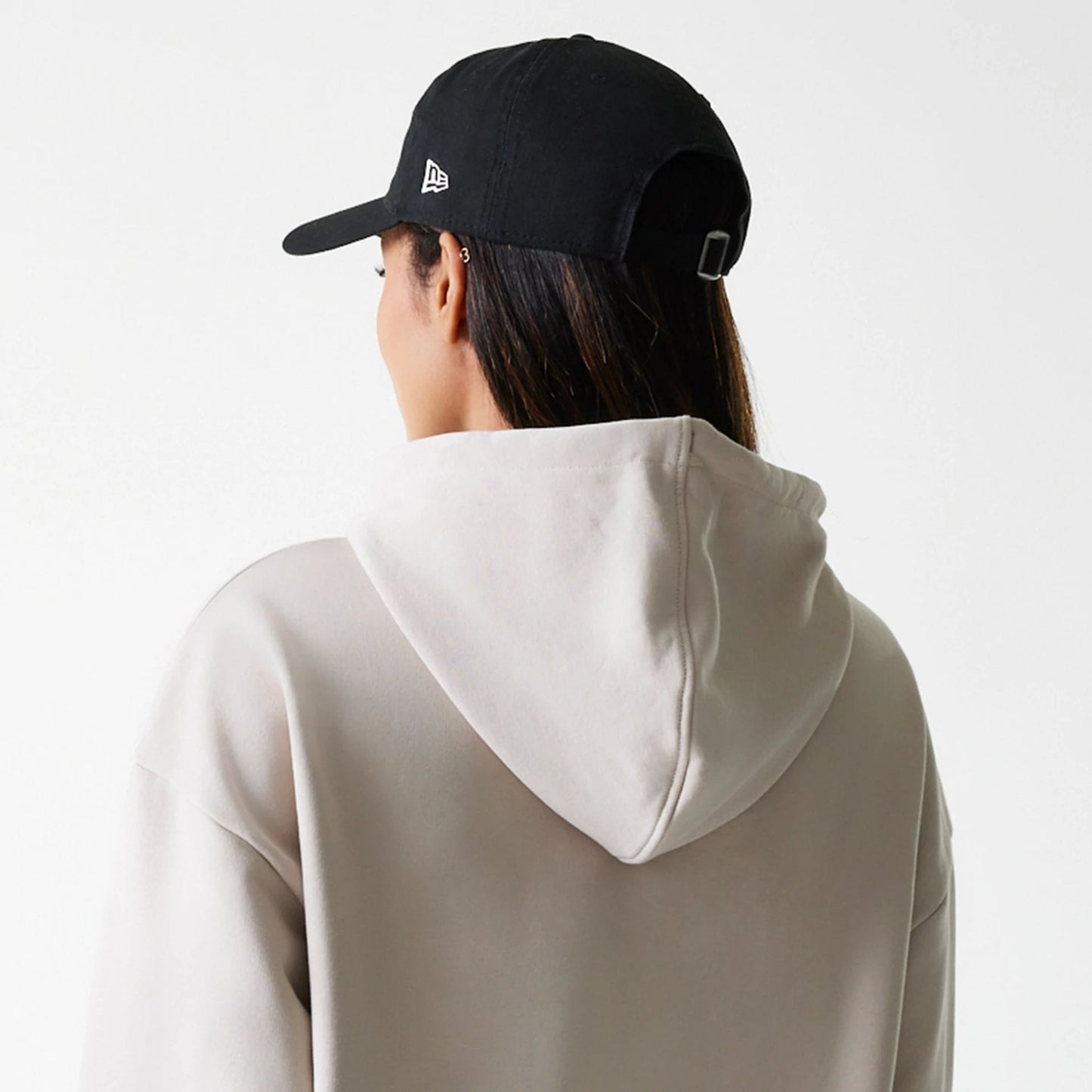 The Female model is wearing Womens New Era Crest Light Beige Pullover Hoodie 7