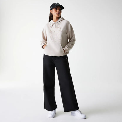 The Female model is wearing Womens New Era Crest Light Beige Pullover Hoodie 8