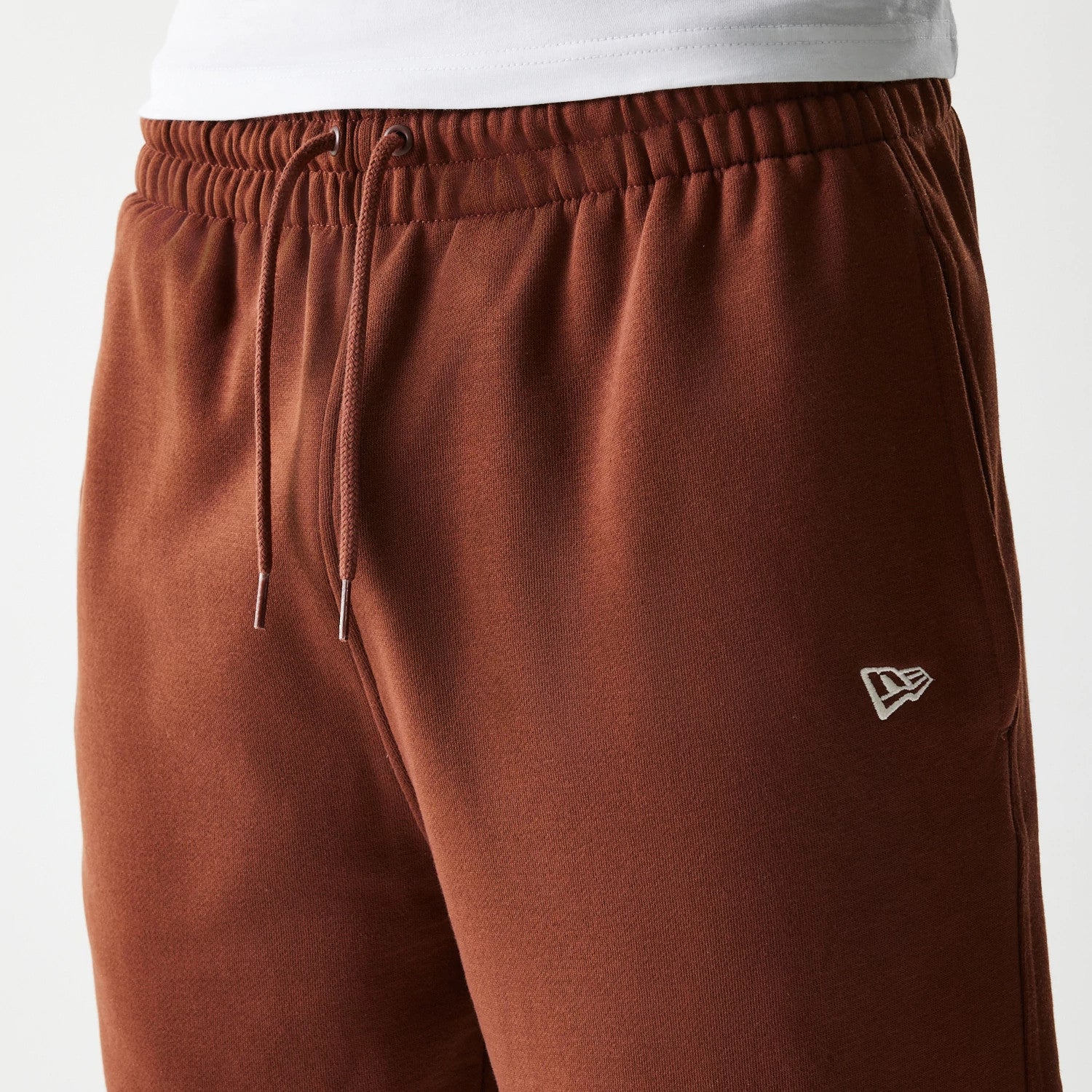 The Male model is wearing New York Yankees MLB Midi League Essential Brown Joggers 4