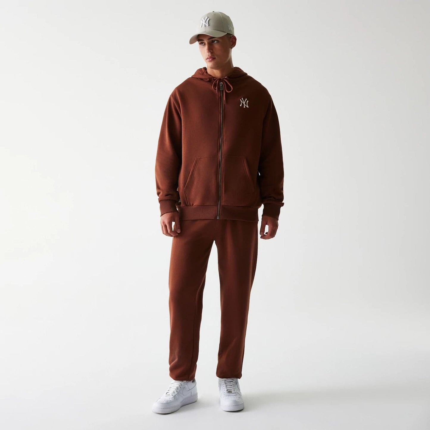 The Male model is wearing New York Yankees MLB Midi League Essential Brown Joggers 8