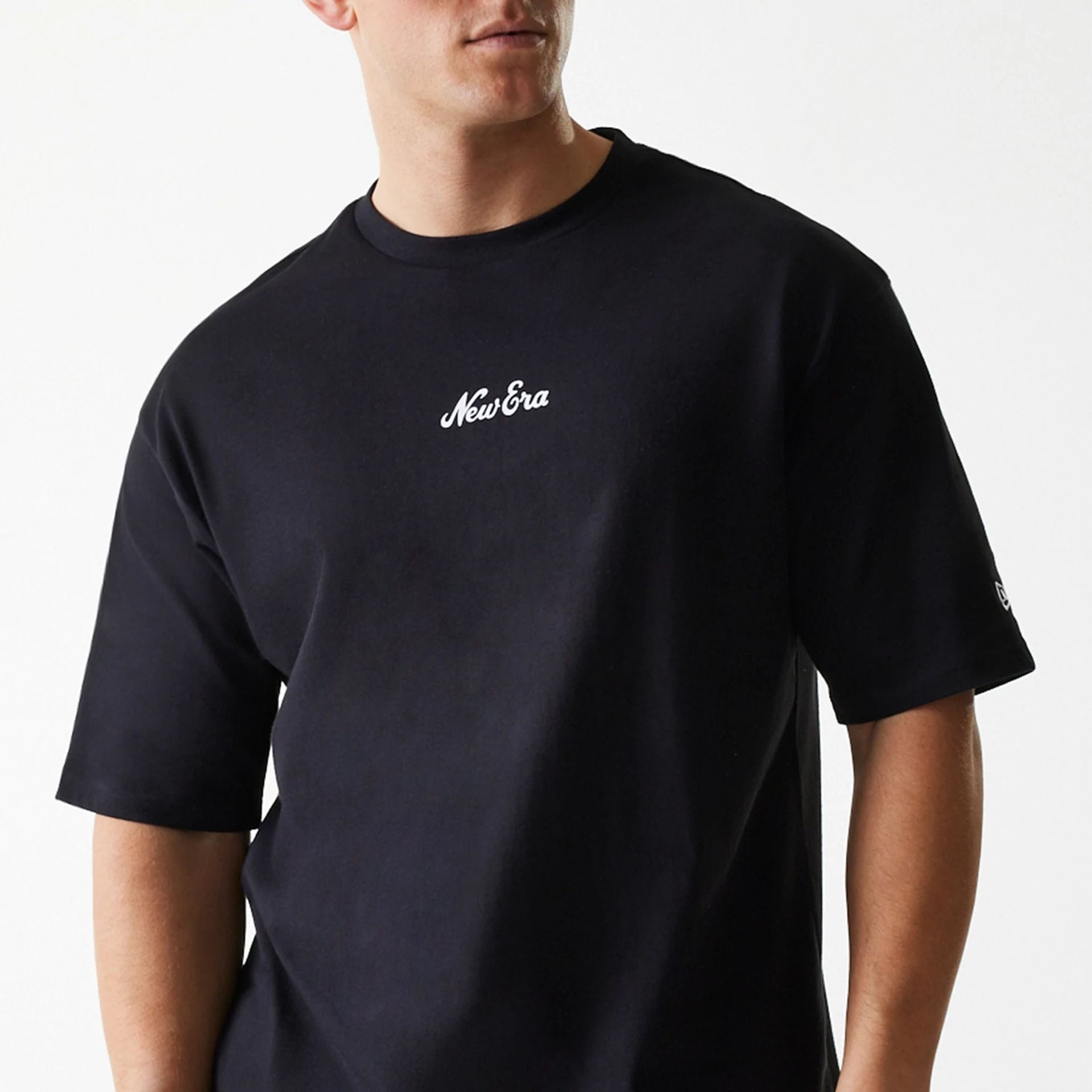The Male model is wearing New Era Trucker Patch Black Oversized T-Shirt 3