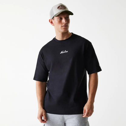New Era Trucker Patch Black Oversized T-Shirt, front view showing the black oversized fit with a raised New Era logo in white on the chest, short sleeves, and a small logo on the left sleeve.