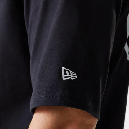 The Male model is wearing New Era Trucker Patch Black Oversized T-Shirt 7