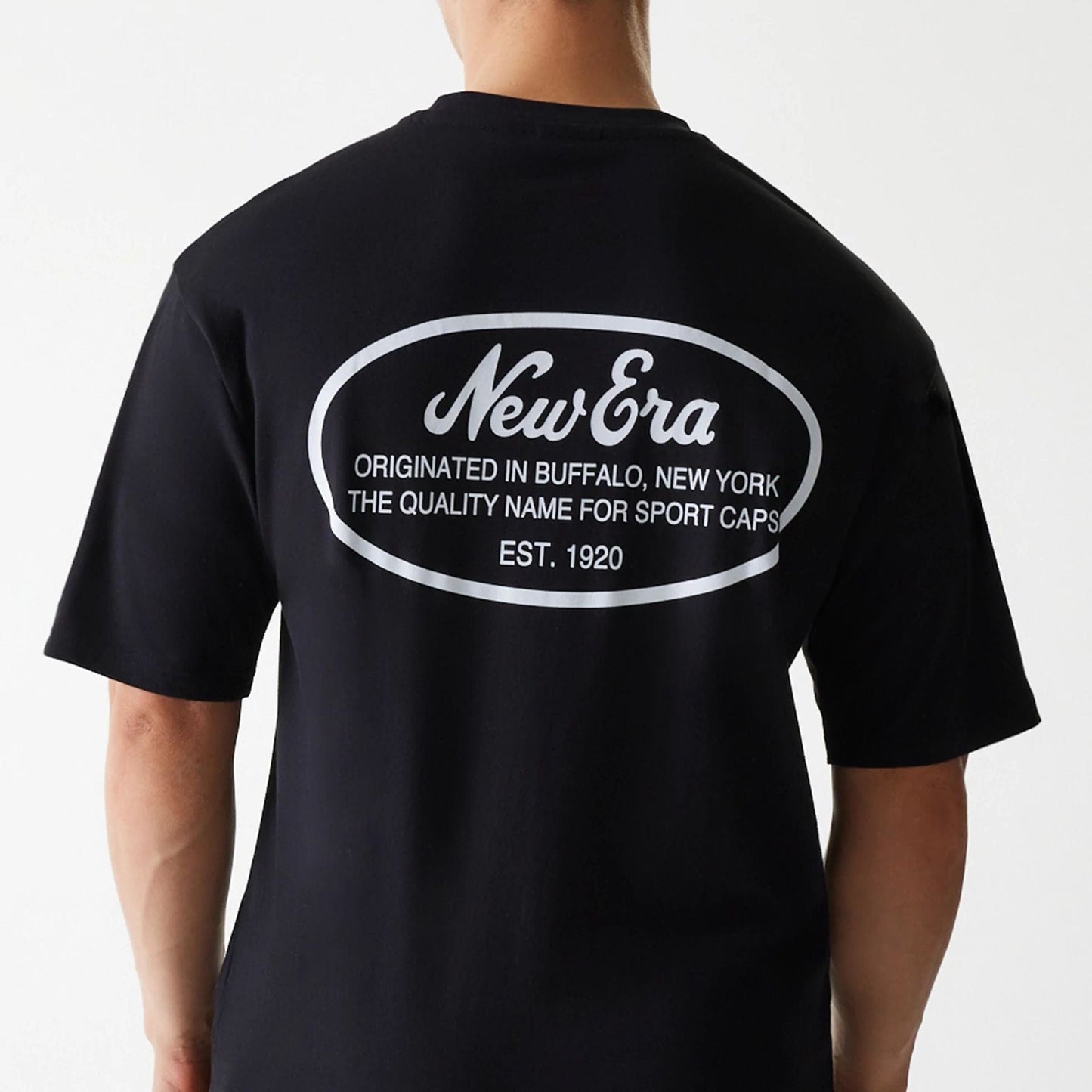 The Male model is wearing New Era Trucker Patch Black Oversized T-Shirt 4