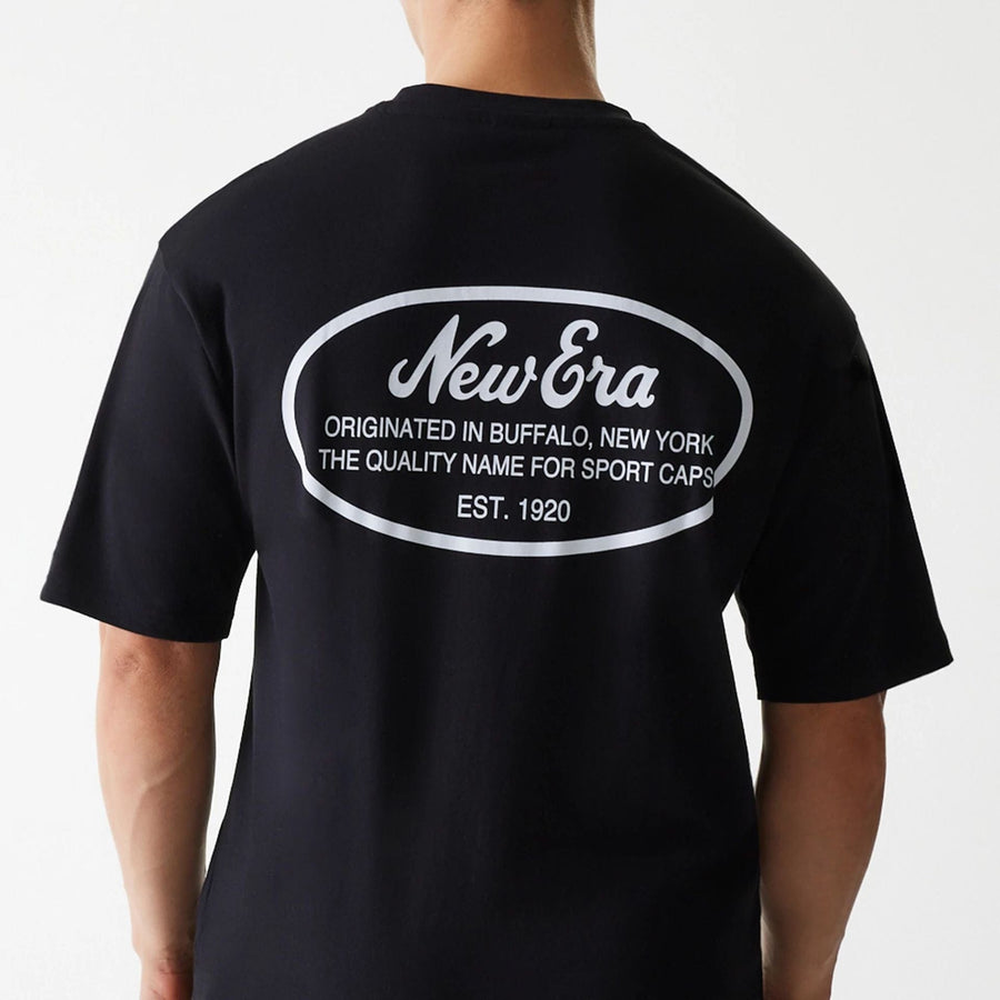 The Male model is wearing New Era Trucker Patch Black Oversized T-Shirt 4