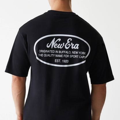 New Era Trucker Patch Black Oversized T-Shirt, back view showing the oversized black shirt with a large white print featuring the New Era logo and text framed within an oval on the upper back.